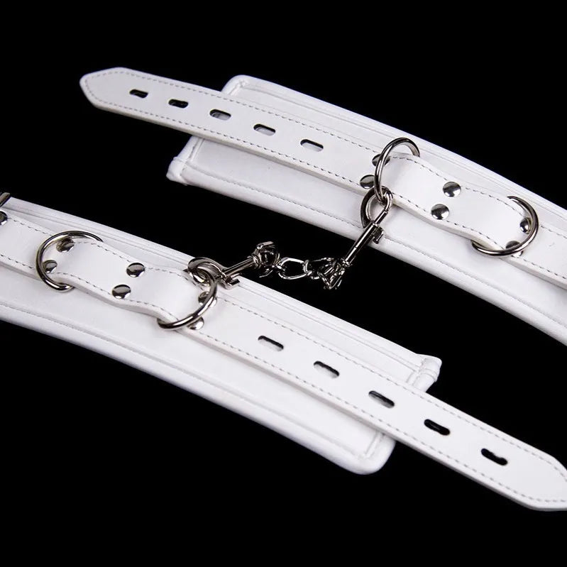 White PU sponge bondage set showing handcuffs, ankle cuffs, and a neck restraint collar.