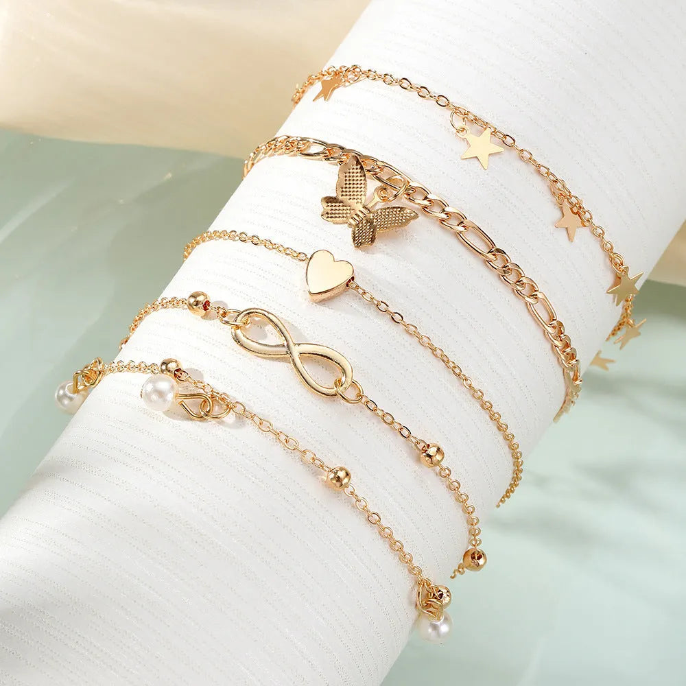 Butterfly pearl heart anklet set containing four alloy foot chain jewellery pieces for women