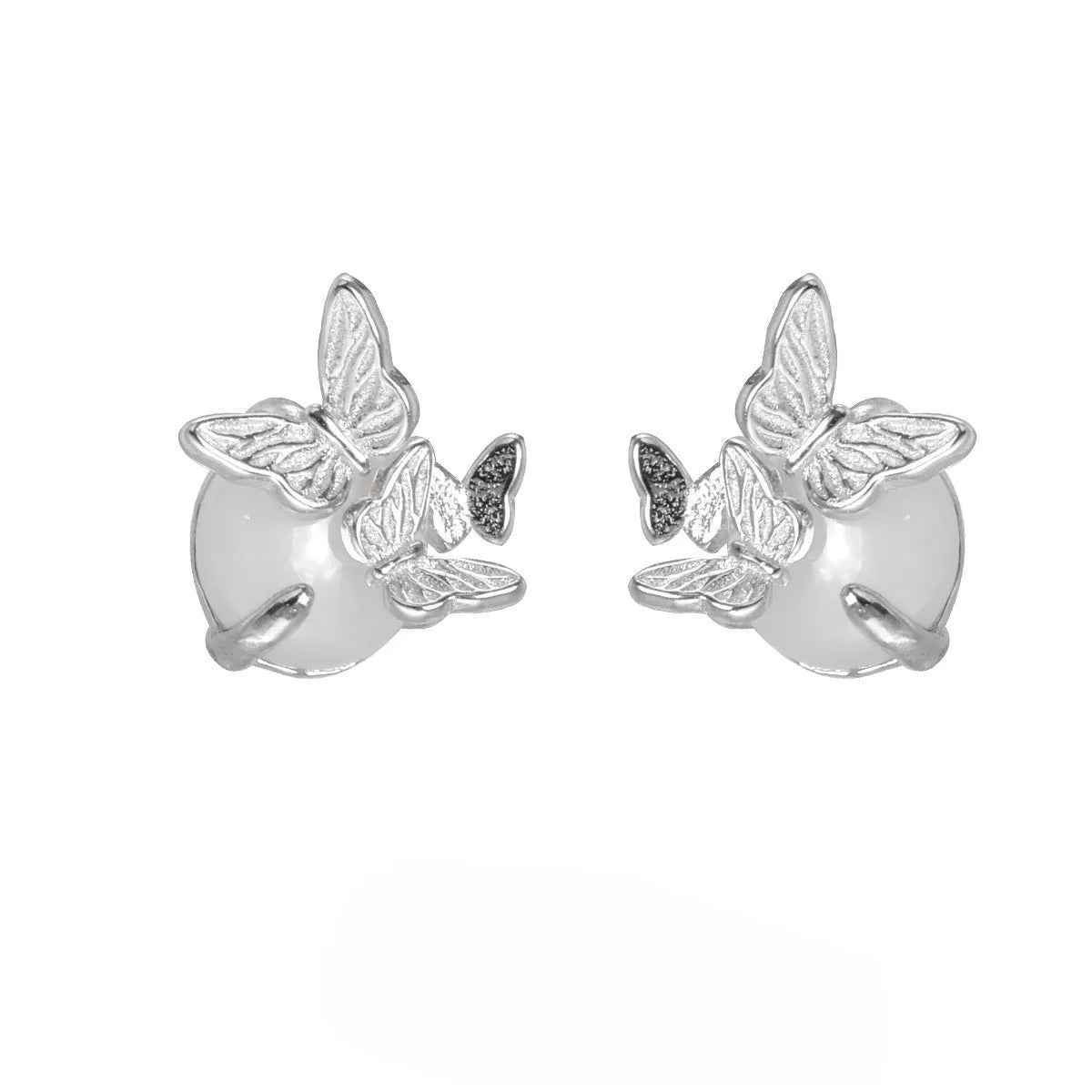 Close-up of 925 silver butterfly stud earrings with animal detail in gold tone finish.