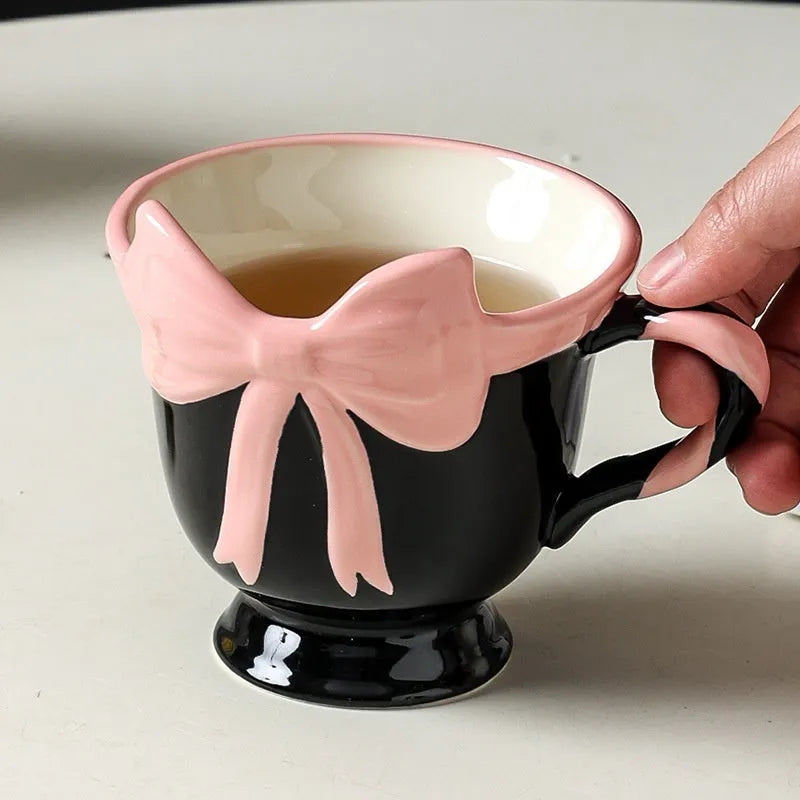 Ceramic mug with heart and bow design in black pink or white powder colour, 301-400ml capacity