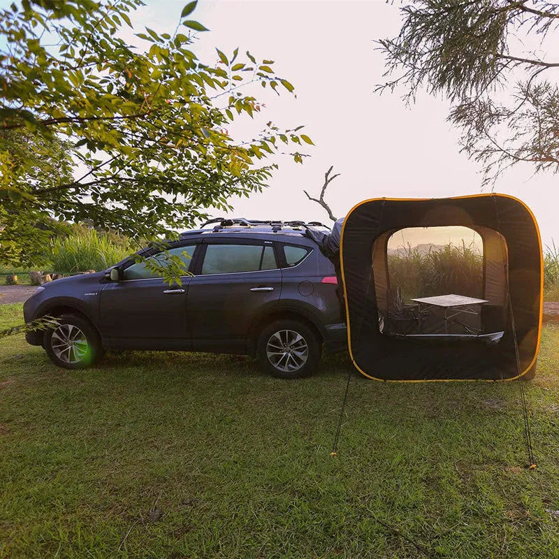 Black pop-up car tail tent with quick-throw setup shown connected to vehicle