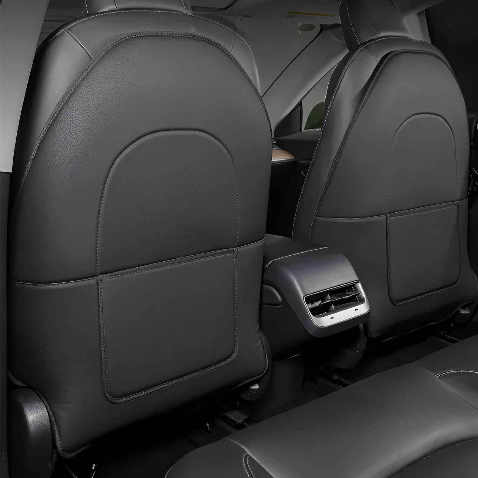 Pair of black leather anti kick pads for car seat backs, showing full coverage and single pocket.