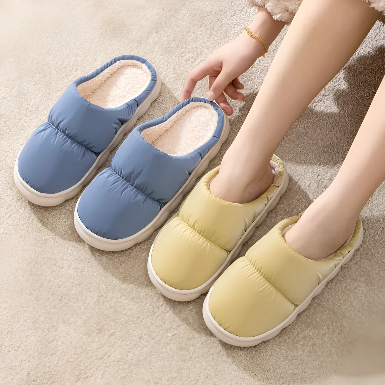 Blue down cotton slippers with artificial leather upper, thick rubber sole, and plush lining shown on a wooden floor.