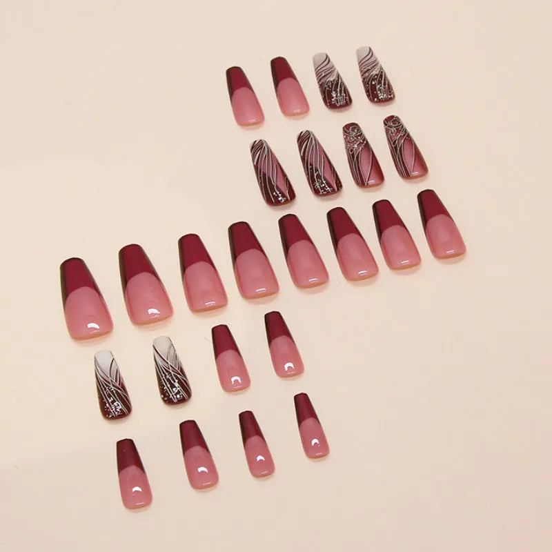 French line pattern fake nails with removable adhesive on plastic backing next to glue tube