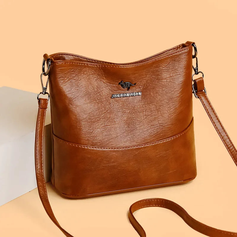Women's leather bucket shoulder bag in solid colour with phone pocket and sandwich pockets