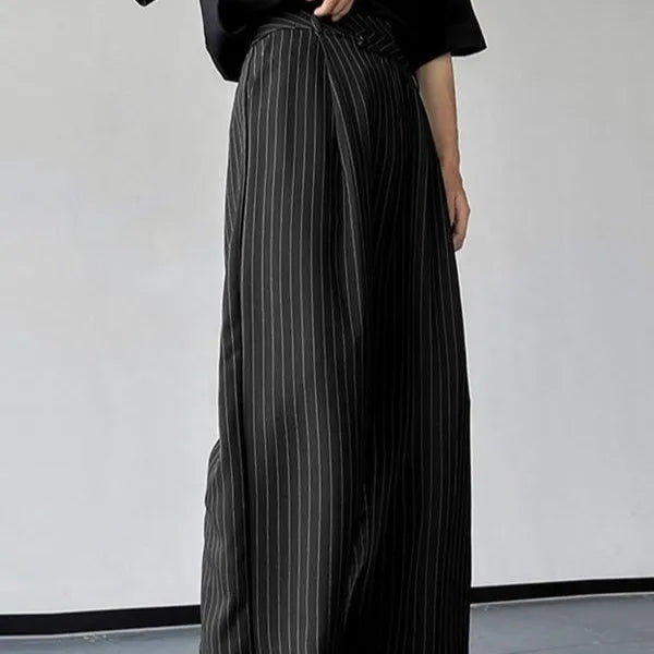 Men's black vertical striped pleated casual trousers with elastic waistband showing front detail