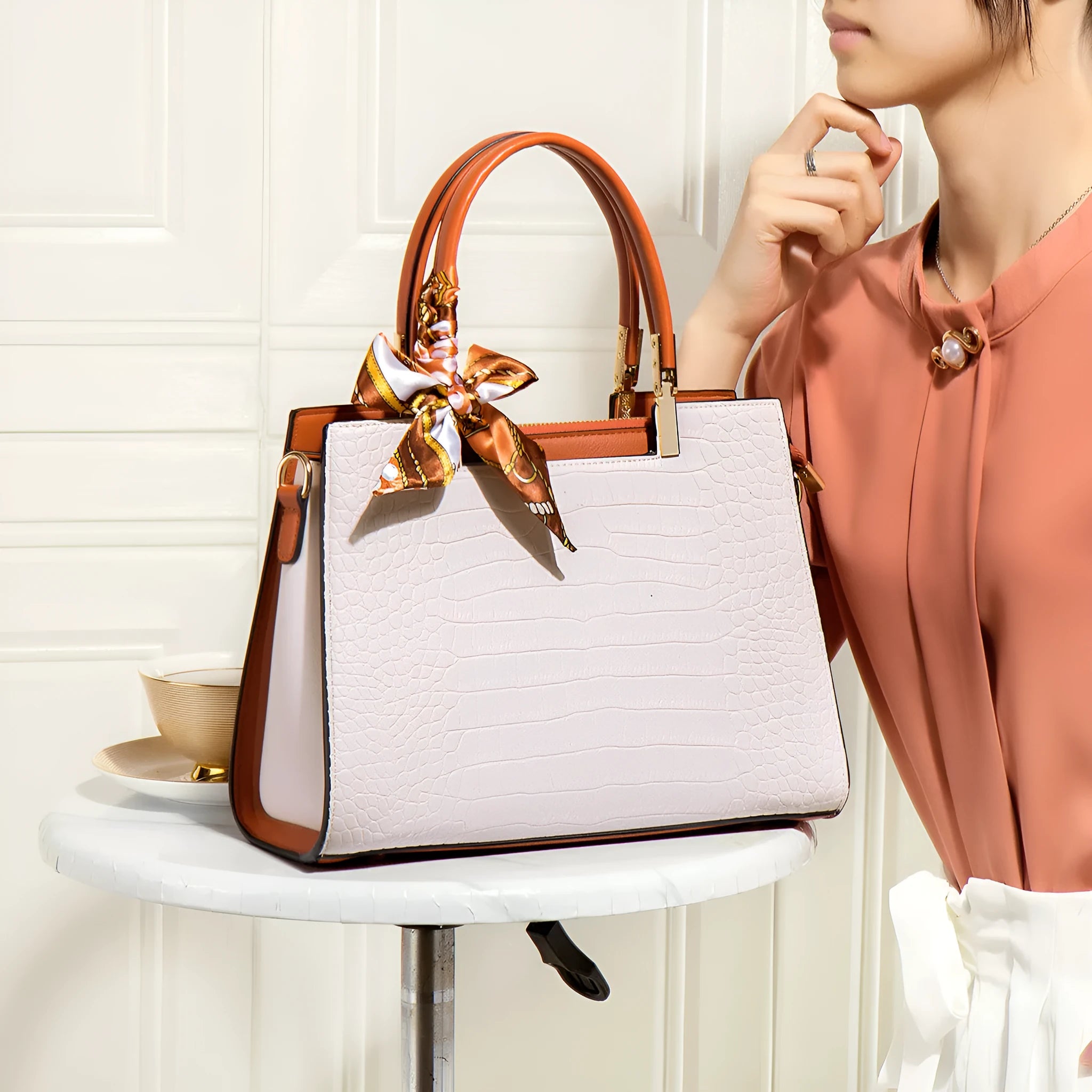 Milky white women's shoulder handbag showing slit pocket and multiple interior compartments