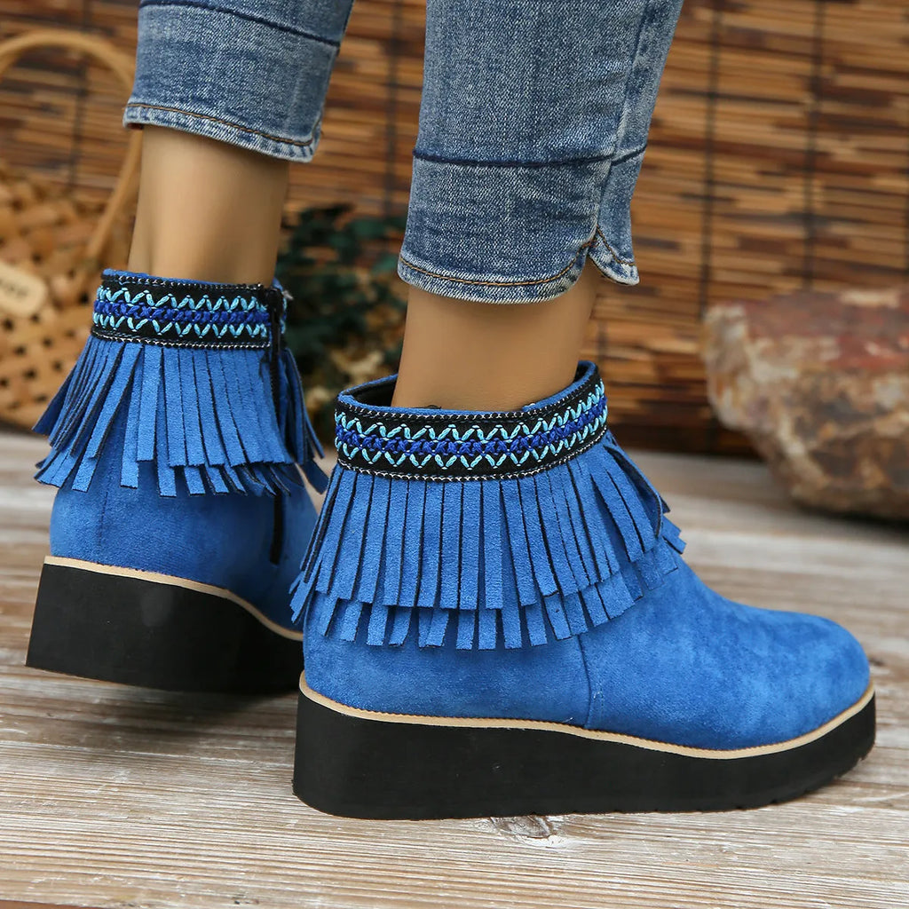 Women's dark brown suede ankle boots with thick platform wedge sole, side zip, and tassel detail.