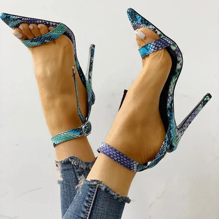 Blue women's high heels with serpentine hollow out design and buckle fastening.