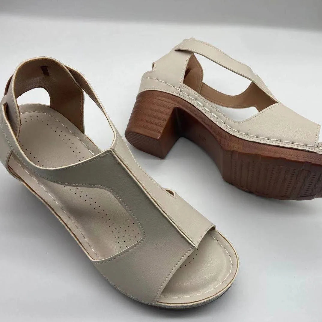Women's peep toe wedge sandals with Roman-style buckle on a low heel.