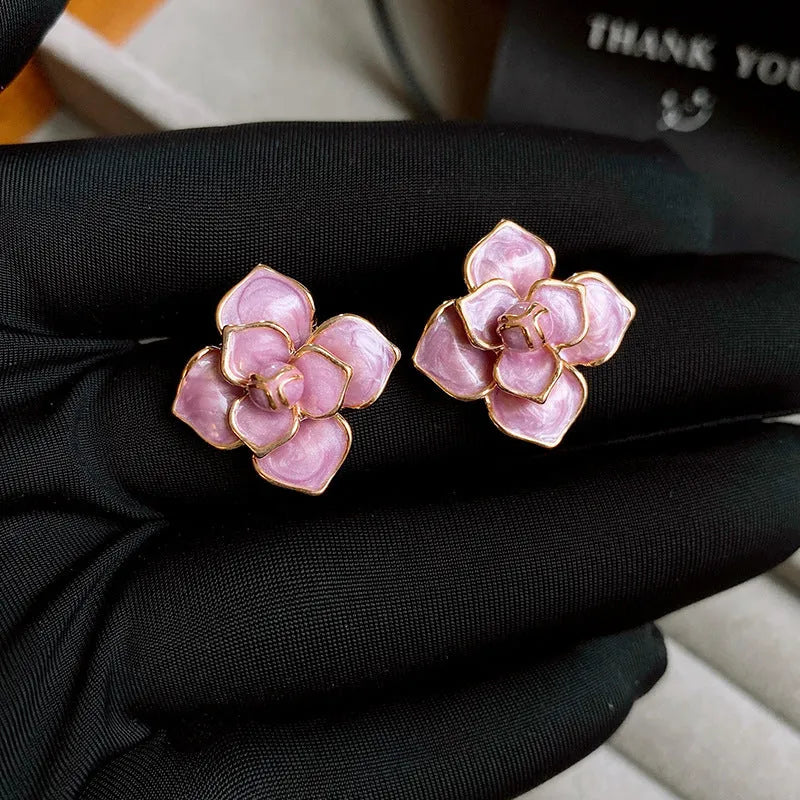 Gold plated purple floral stud earrings with oil-spot glaze colour variation on copper