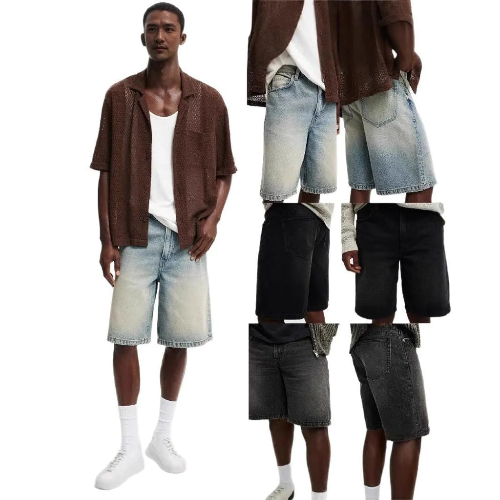 Man wearing loose light blue straight leg cotton denim jeans for casual summer streetwear.