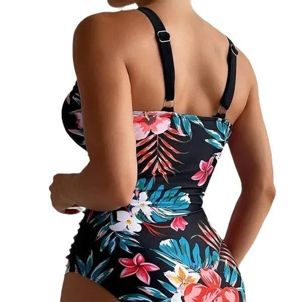 Women's floral patterned backless one-piece swimsuit on a mannequin.