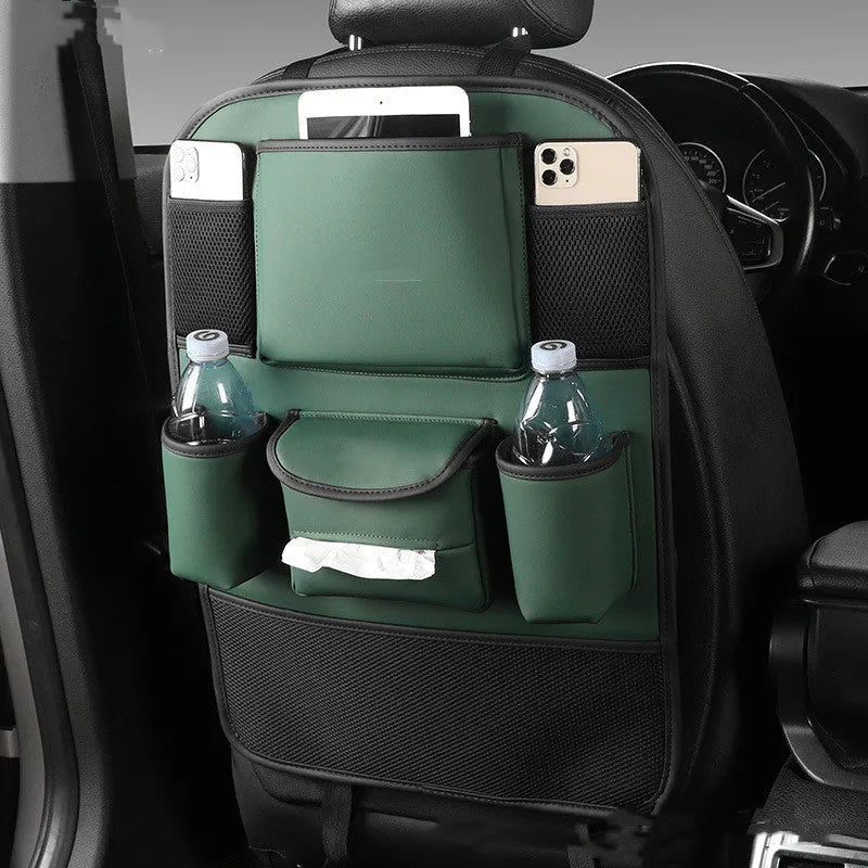 Synthetic leather car seat back storage bag hanging on the back of a grey car seat.