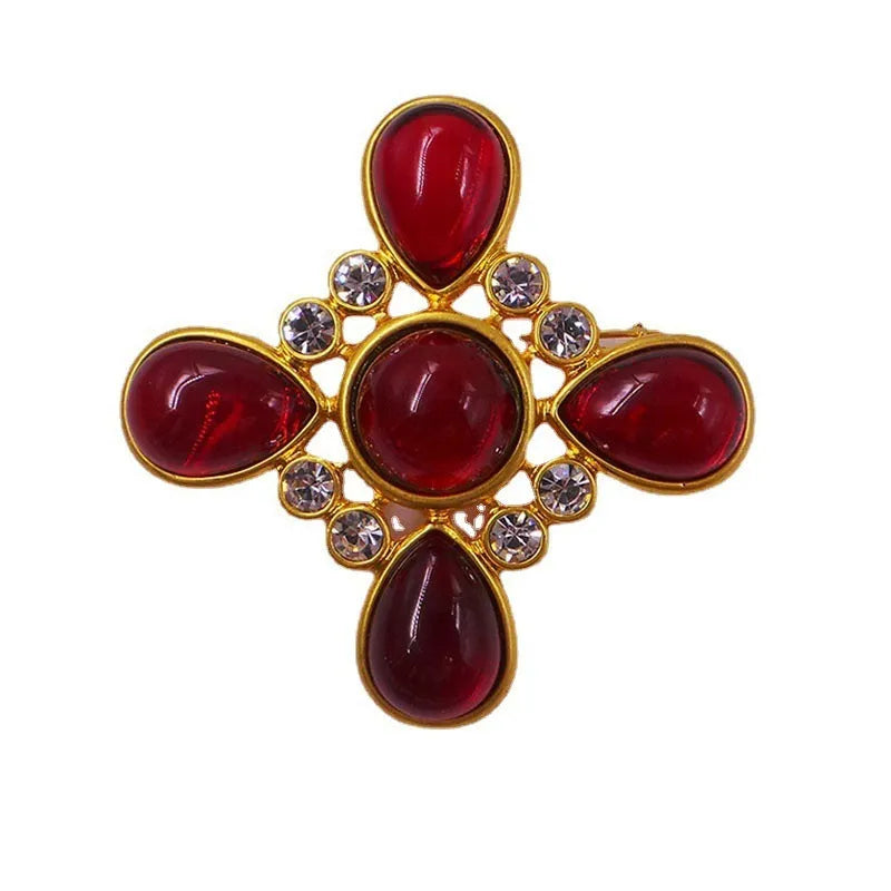 Classic vintage zinc alloy brooch with baroque-style cross design and crystal details on a dark background.