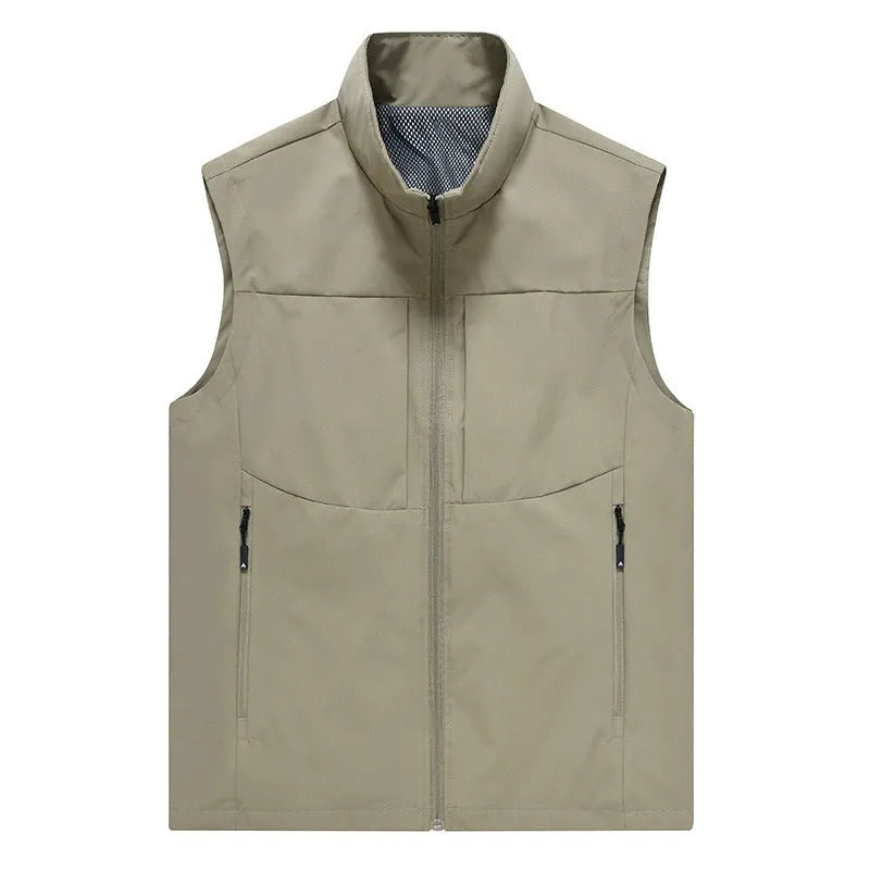 Man wearing a khaki stand collar cardigan vest with zipper pockets outdoors.