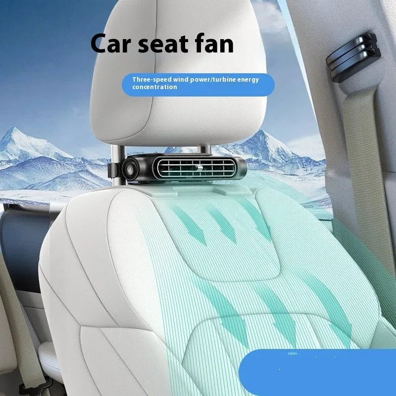 A black USB-powered car fan with Velcro strips mounted on a car seat headrest, showing the fan grille and control button.