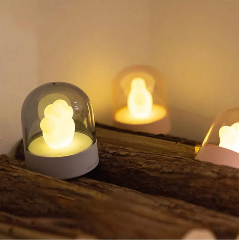 Grey cat paw shaped night light with USB charging cable and adjustable brightness controls