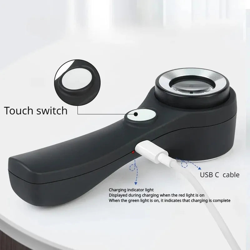 Black handheld magnifying glass with LED light for jewellery and coin appraisal.