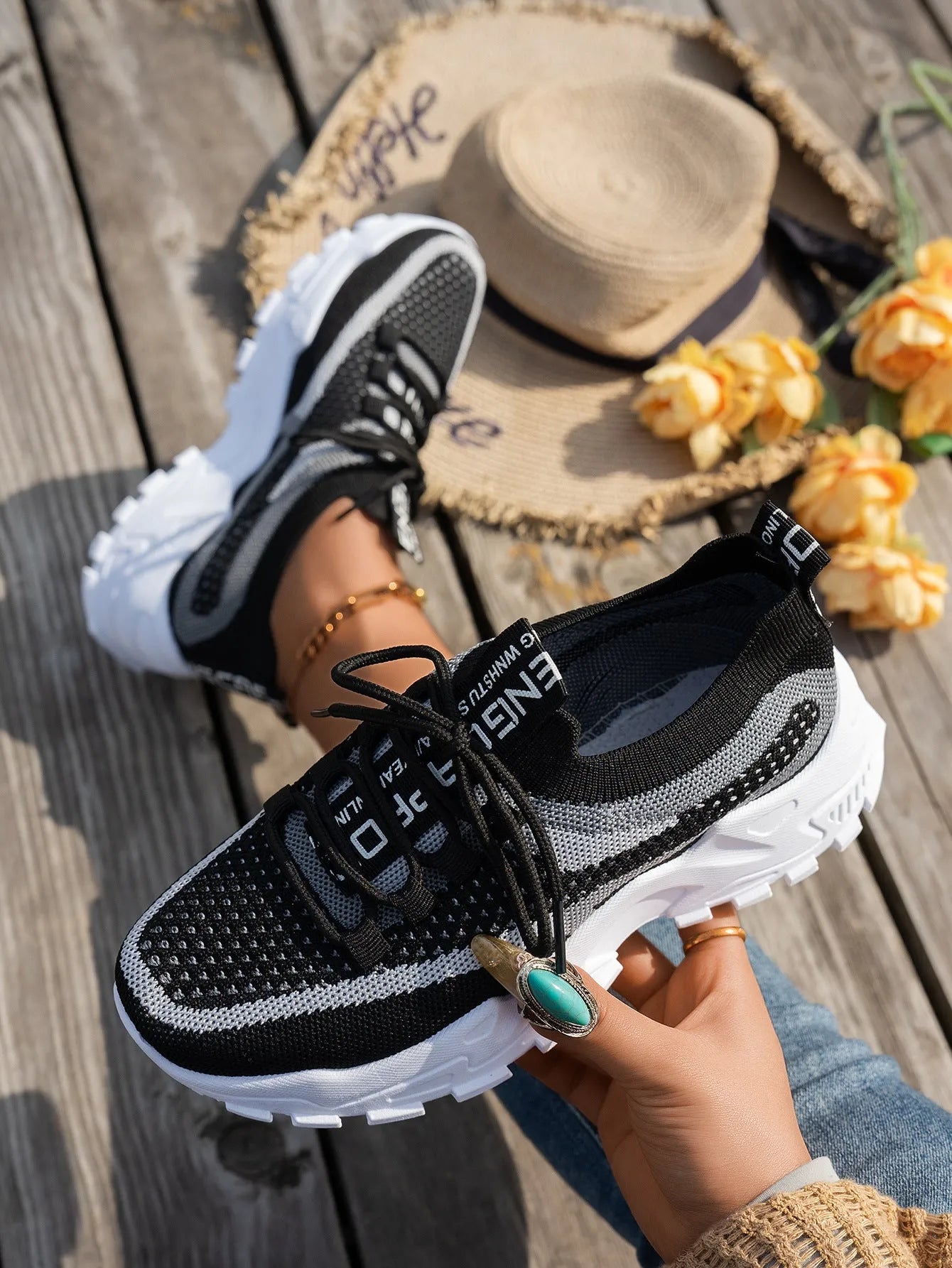 Women's flyknit mesh sneakers with rubber sole and lace-up design in black and gray