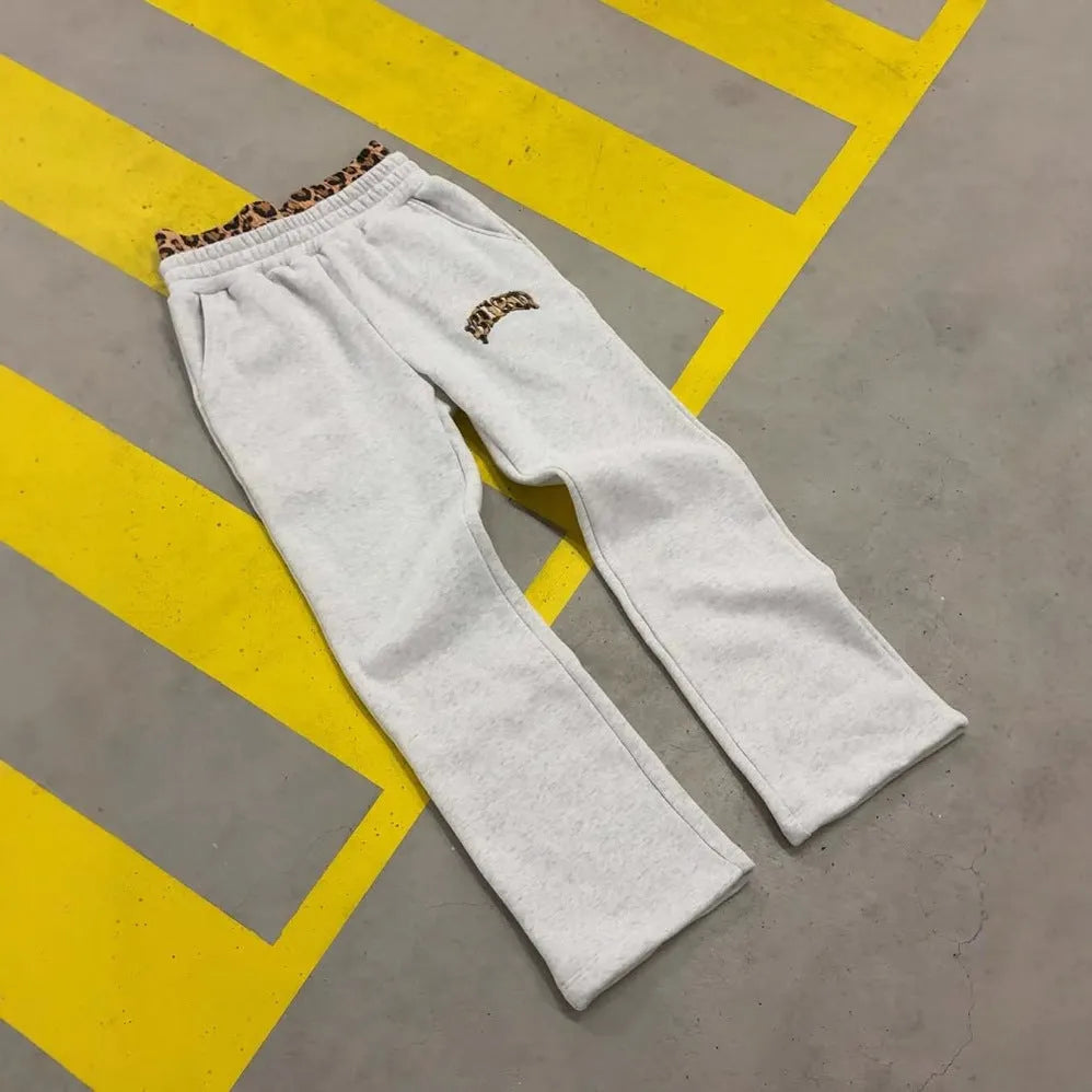 Men's grey patchwork double waist loose hip hop trousers on a hanger