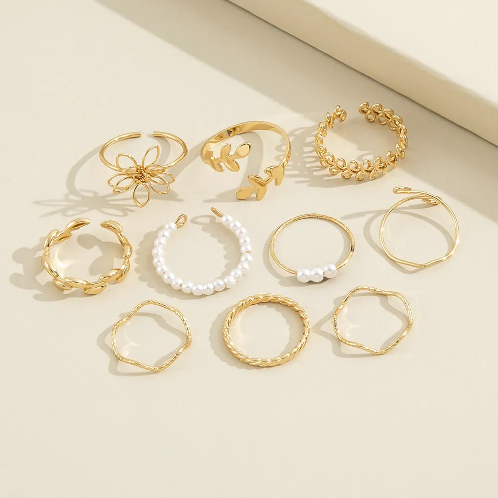 Gold-coloured alloy ring with openwork flower design and glossy electroplated finish