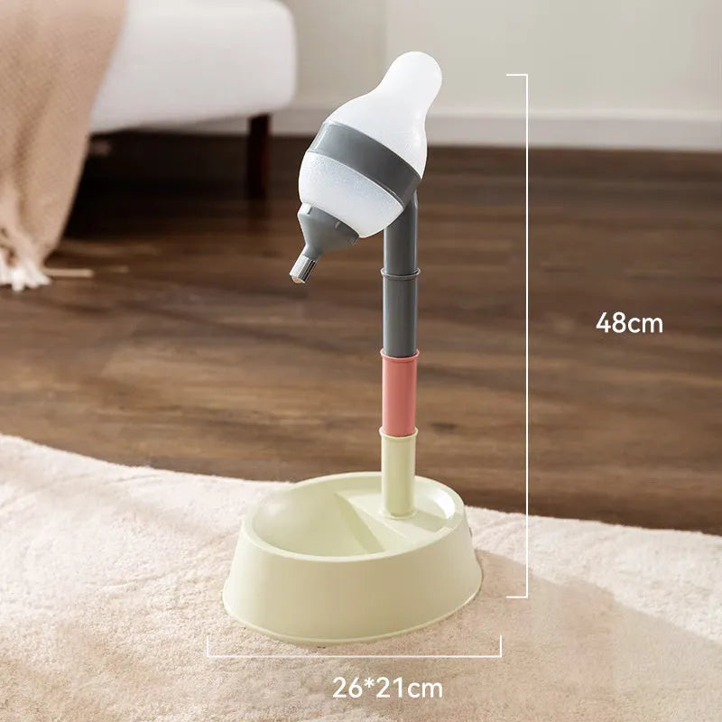 Green adjustable pet water dispenser with detachable pole and steel drinking nozzle on a grey floor.