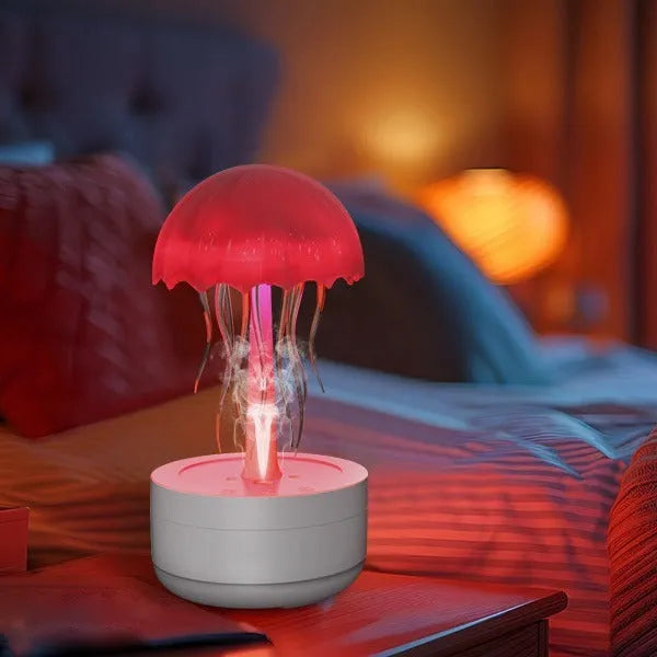 White jellyfish-shaped aroma diffuser and humidifier with glowing coloured LED light on a desk.