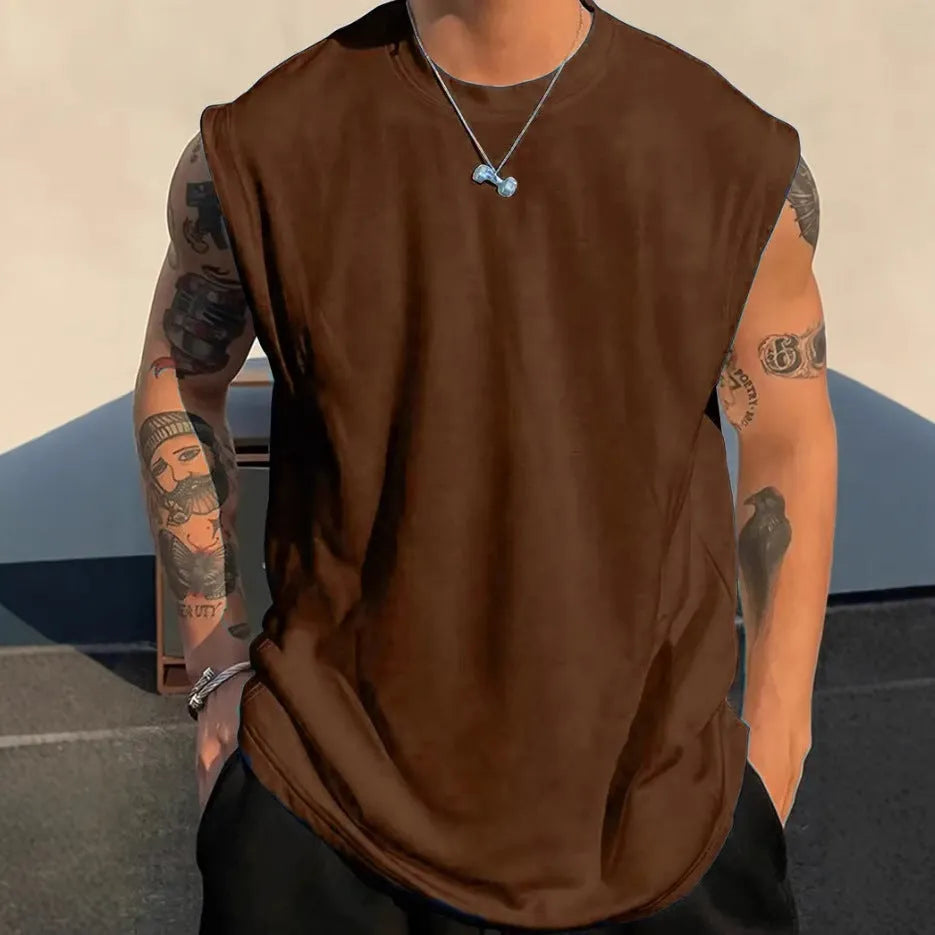 Man wearing a loose apricot-coloured cotton tank top, showing the sleeveless design and straight hem.