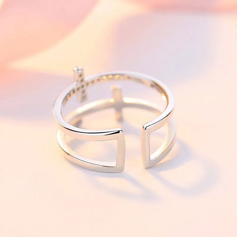 Adjustable copper ring with zircon stones in geometric design, showing open ring construction