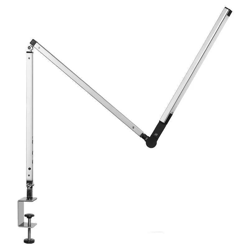 Black folding clip-on LED desk lamp with remote control on a wooden desk.
