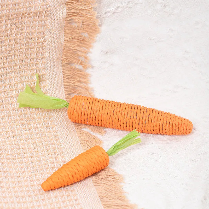 Assortment of cat toys including carrot bites, paper toys, ringing stones, sticks and tooth grinding sticks