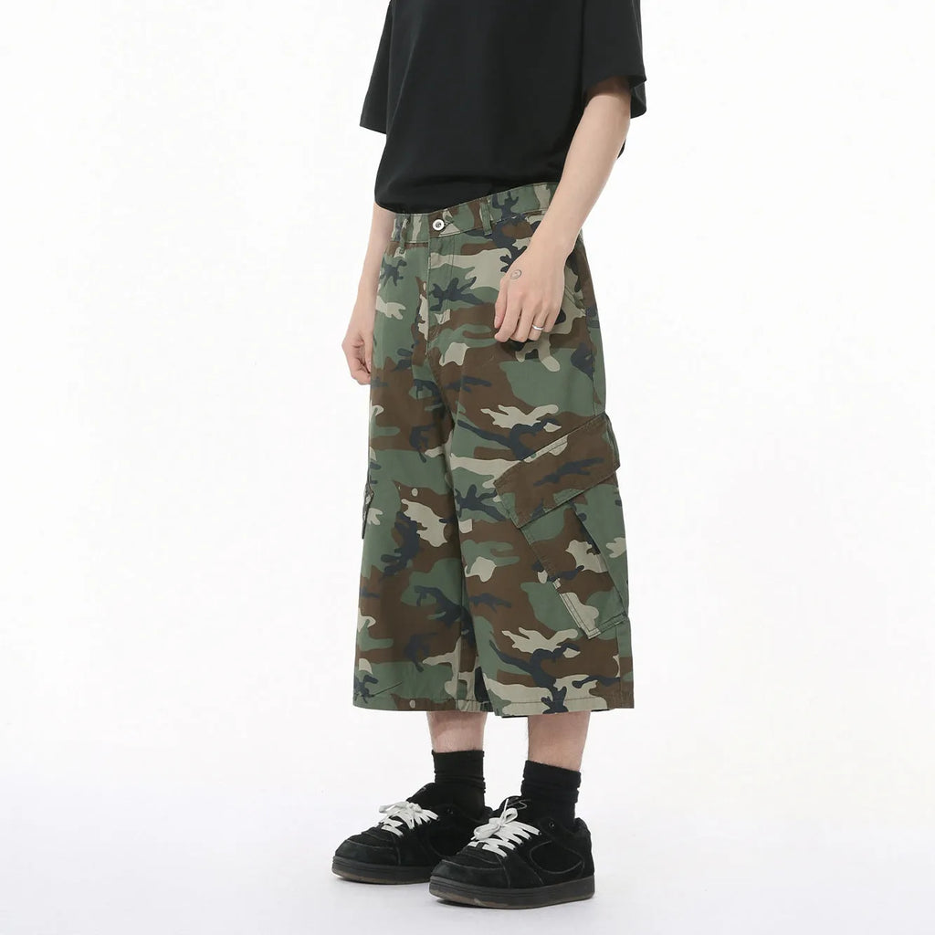Men's camouflage coloured wide-leg cropped jeans with large side pockets.