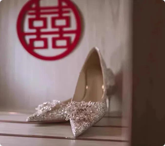 Champagne coloured women's wedding high heel shoes with crystal decoration and a pointed toe.