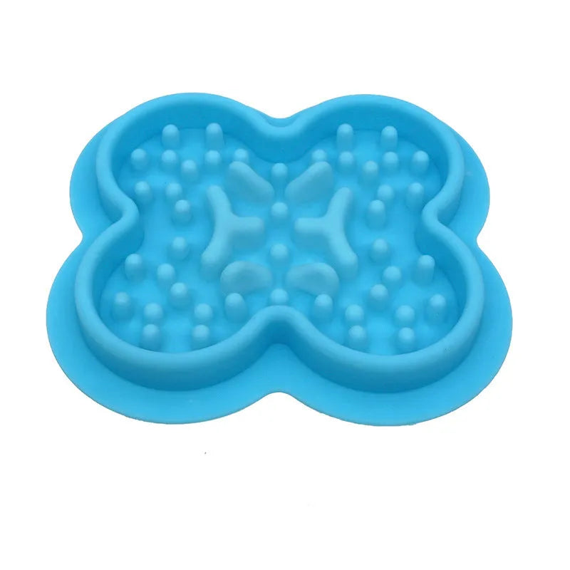 Silicone slow feeder licking pad for pets in various colours on a kitchen floor