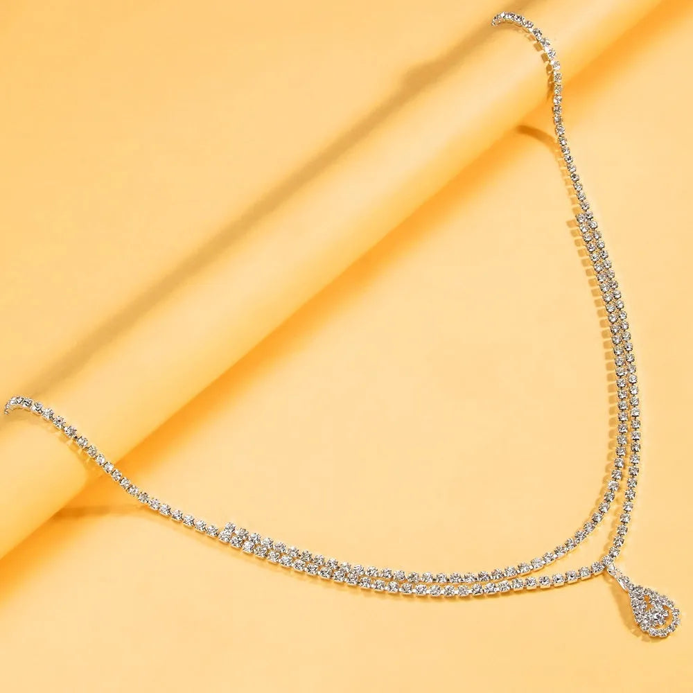 Gold waist chain with water drop pendant and tassel decoration, lobster buckle closure