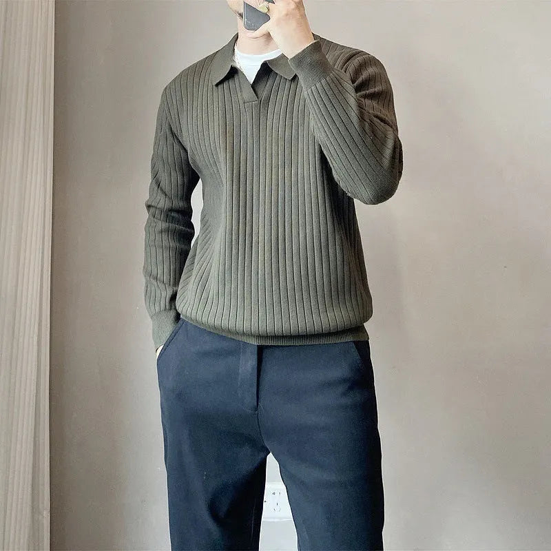 Man wearing a black and white striped knitted jumper with a lapel collar.