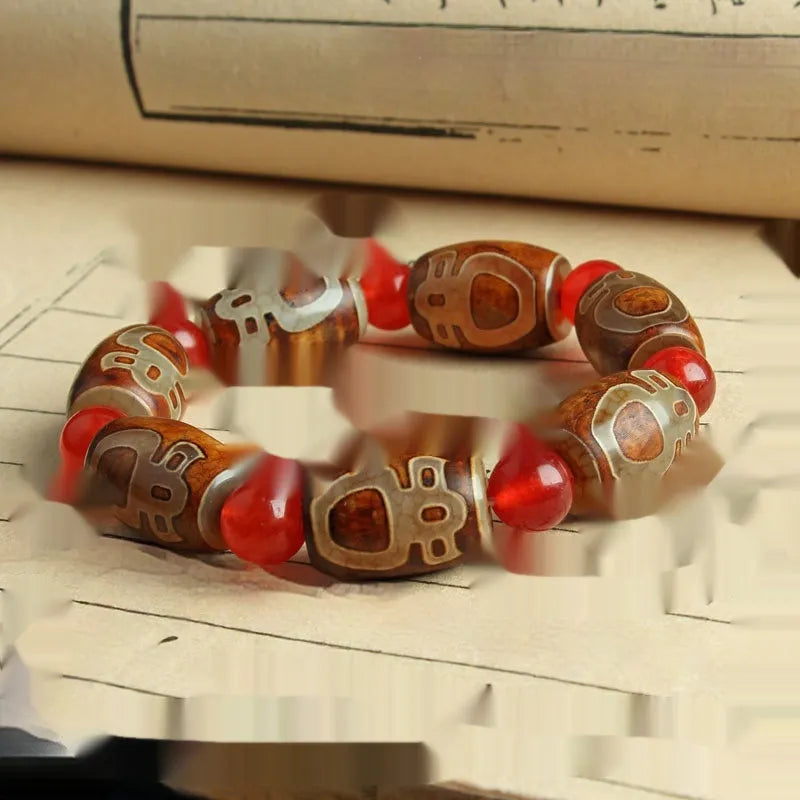 Distressed agate bracelet with traditional Tibetan dzi beads including three-eye and Nine Eyes designs.