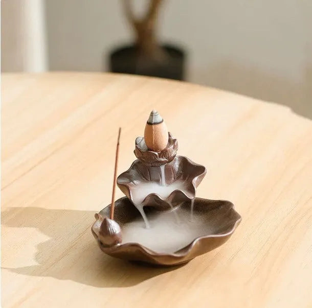 Ceramic reverse flow incense burner with purple clay construction and traditional good luck decorative motifs