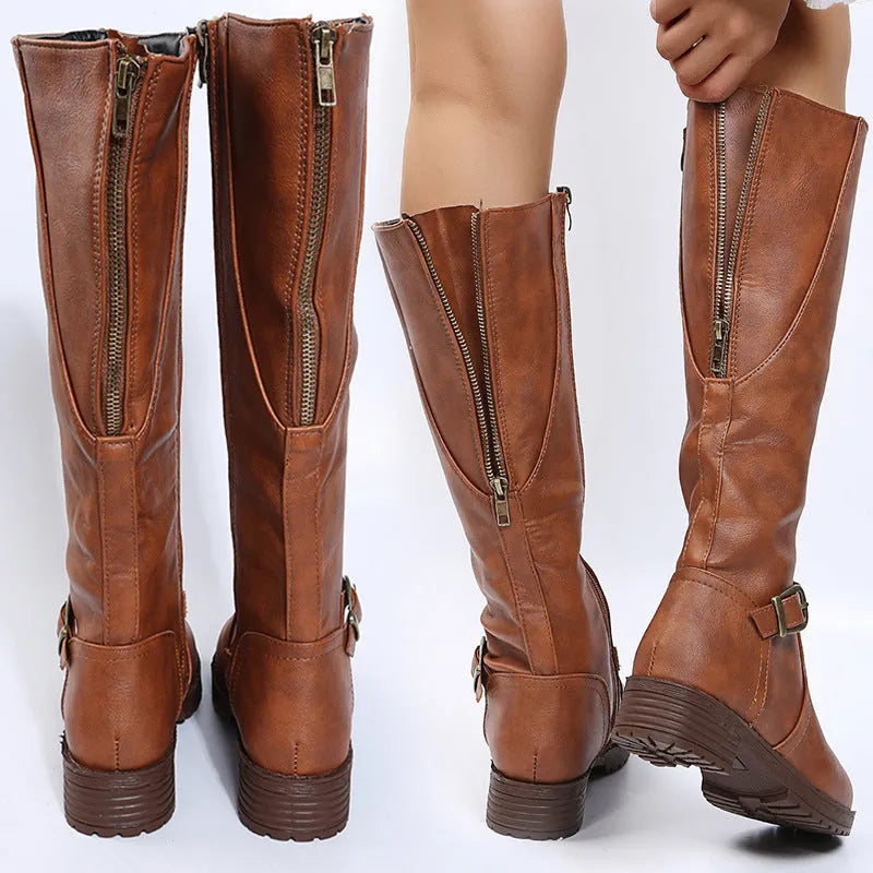 Women's black knight boots with a square heel, buckle detail on the upper, and a high shaft.