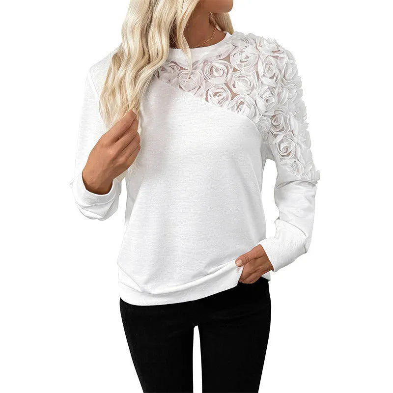 White women's long sleeve loose fit top with floral pattern.