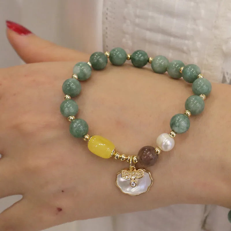 Adjustable green jade bead bracelet with a natural shell clasp fastening.