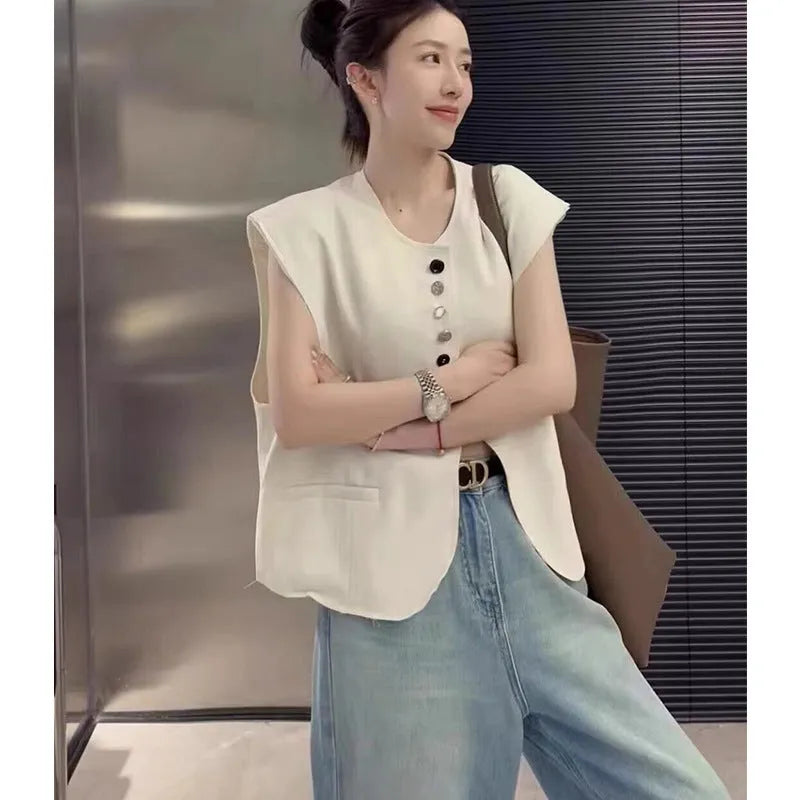 Women's short-length polyester vest in milky white, showing loose fit and front pockets
