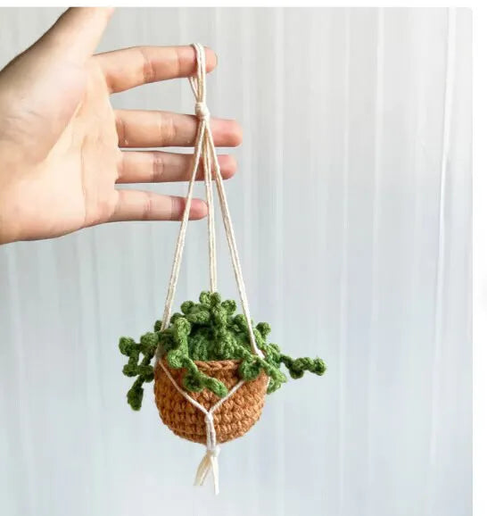 Green and white knitted wool car plant decoration with plastic base and hanging rope