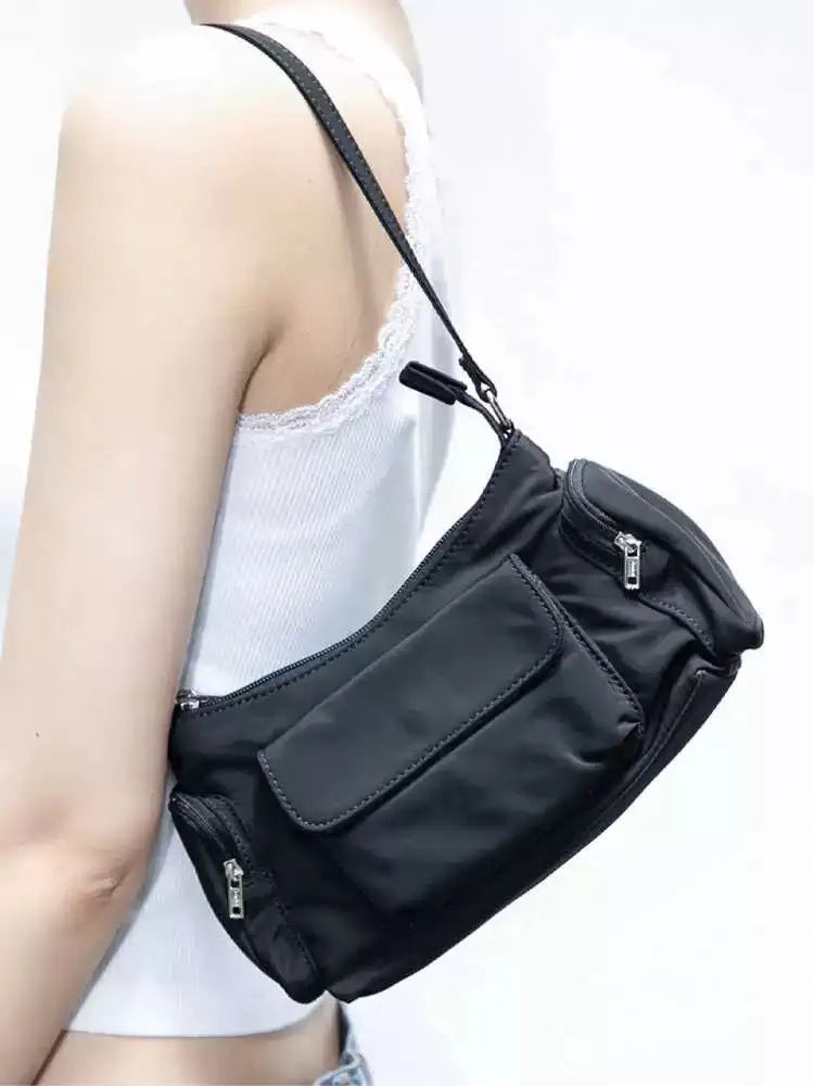 Black double pocket shoulder bag with side line detailing showing interior organisation