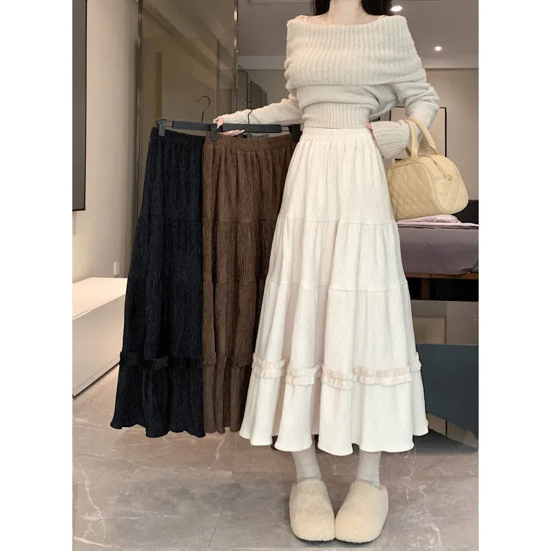 Beige corduroy A-line midi skirt with an elastic waistband on a hanger.