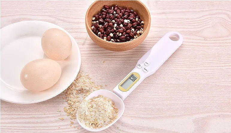 Black electronic measuring spoon scale showing digital display and integrated spoon design for kitchen weighing