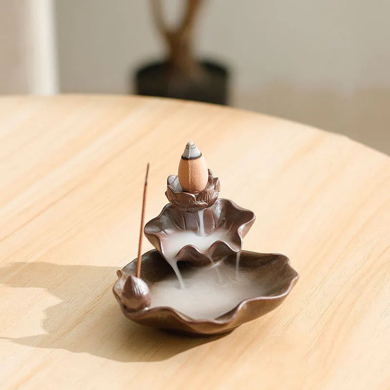 Ceramic reverse flow incense burner with purple clay construction and traditional good luck decorative motifs