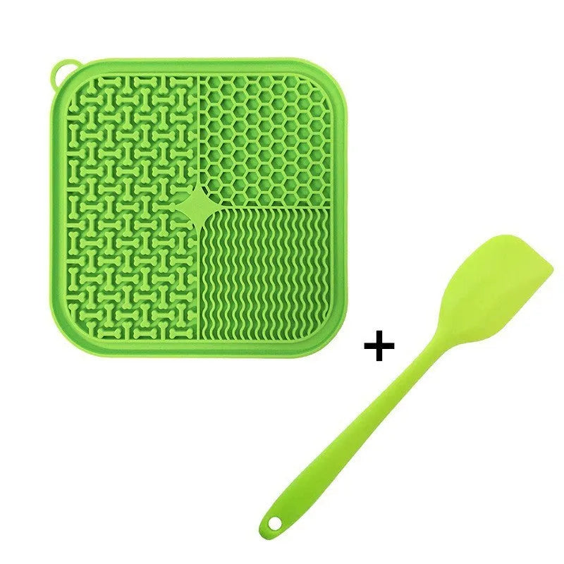 Blue silicone dog lick mat with textured pattern and suction cups on a table.