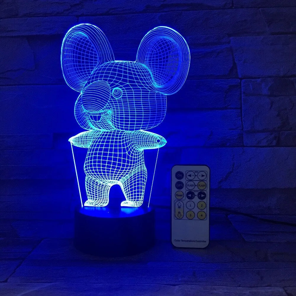 Black koala-shaped LED night light with remote control on a white surface